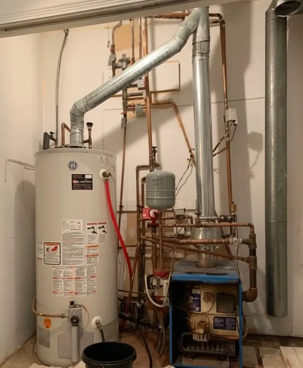 Old water heater and boiler system with metal pipes and ducts